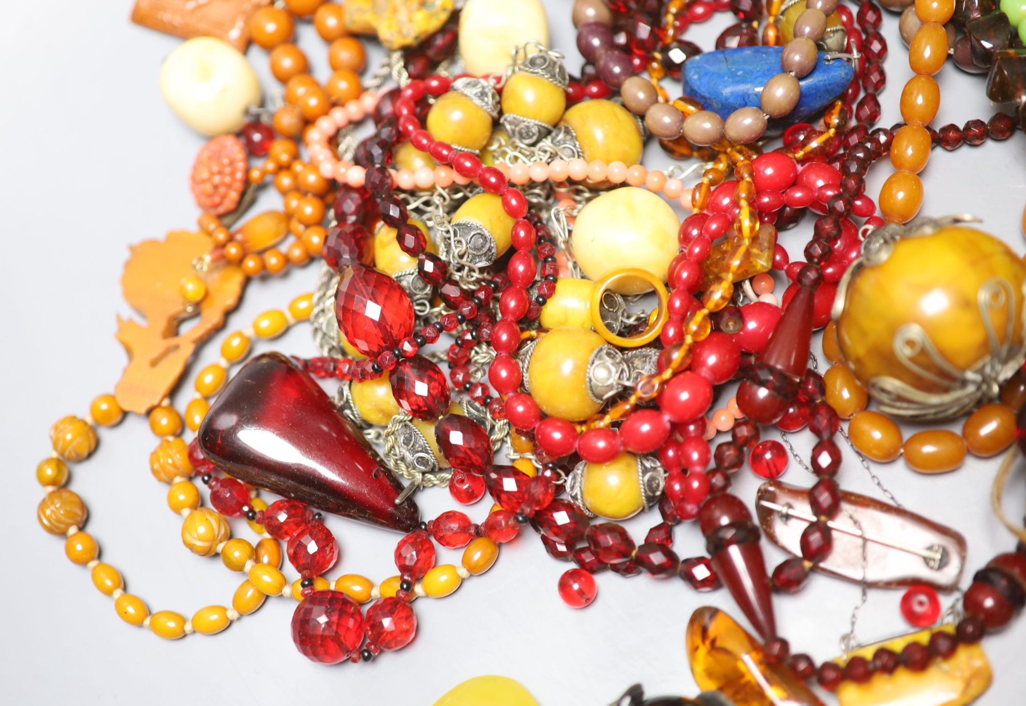 A group of assorted costume jewellery including faux amber etc.